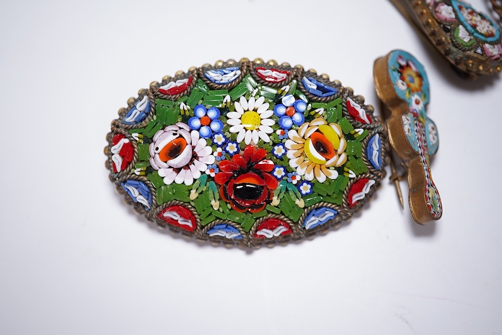 Thirty-one costume micro-mosaic brooches, to include seventeen guitar and banjo shaped brooches, five large oval/ circular brooches including scenic swan brooch, eight, smaller brooches and a pendant. Condition - fair/go